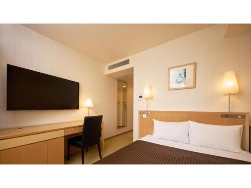 a hotel room with a bed and a desk and a television at The OneFive Tokyo Kameido - Vacation STAY 64610v in Tokyo
