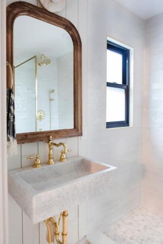 a bathroom with a white sink and a mirror at The Bend Micro Resort in Phoenicia