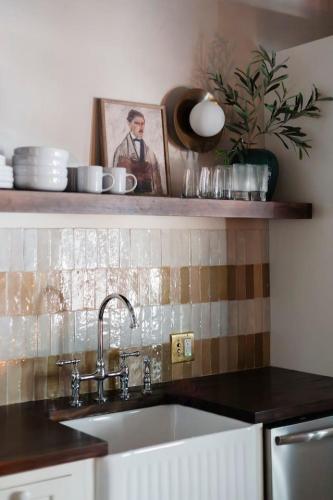 a kitchen with a sink and a picture on a shelf at The Bend Micro Resort in Phoenicia