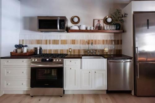a kitchen with a stove and a microwave at The Bend Micro Resort in Phoenicia