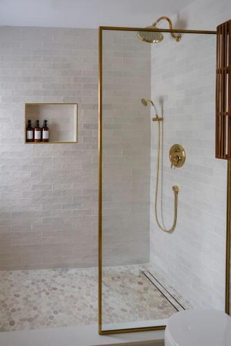 a shower with a glass door in a bathroom at The Bend Micro Resort in Phoenicia