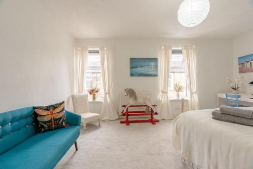 a living room with a blue couch and a chair at Clitheroe Wilson Retreat. Central Lancashire in Clitheroe