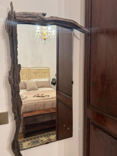a mirror reflection of a bed in a bedroom at Babaia in Volterra