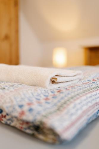 a pile of towels sitting on top of a bed at Gazdovský dvor B&B s Mini Wellness in Bešeňová