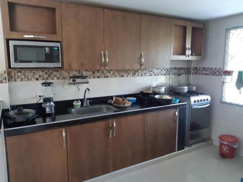a kitchen with a sink and a stove at Casa Finca la Parcela in San Onofre
