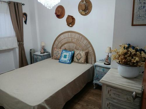 a bedroom with a large bed with blue pillows on it at Casa Maria T1 in Armação de Pêra