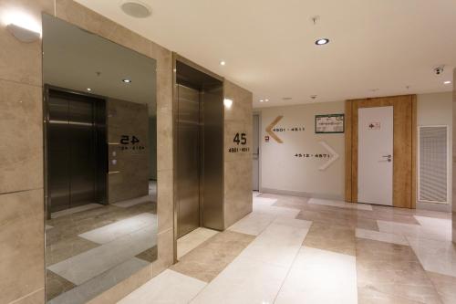 an empty lobby with glass doors and tile floors at Orbi Batumi in Batumi