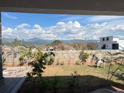 a view of a yard with a wall and mountains at Green Hills View in Islamabad