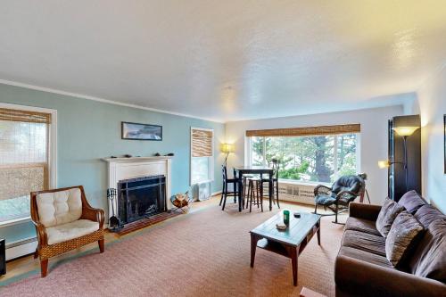 a living room with a couch and a fireplace at Whispering Seas with Hot Tub! in Newport