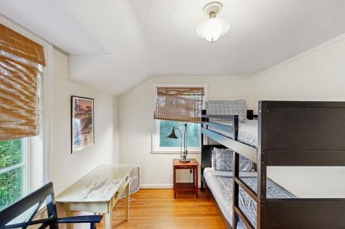 a room with two bunk beds and a table at Whispering Seas with Hot Tub! in Newport