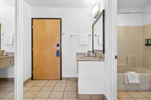 a bathroom with a sink and a toilet and a mirror at Best Western Liberty Inn in Delano