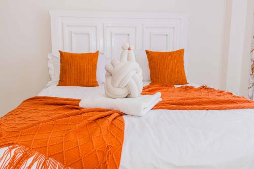 a bed with two stuffed animals sitting on it at Urban suites 2 bedroom Master ensuite holiday rental nanyuki in Nanyuki
