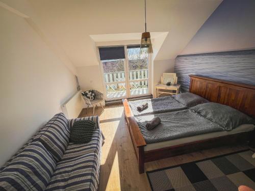 a bedroom with a bed and a couch at Patent, your home in Badacsony in Badacsonytomaj