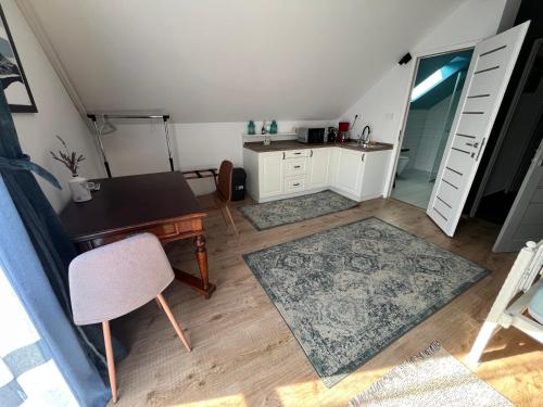 a room with a desk and a table and a kitchen at Patent, your home in Badacsony in Badacsonytomaj