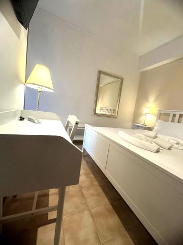 a bedroom with a bed and a desk and a mirror at Dream Stay Nettuno in Nettuno