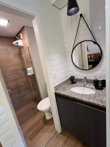 a bathroom with a sink and a mirror at Travellar Spot 12 in Ribeirão Preto
