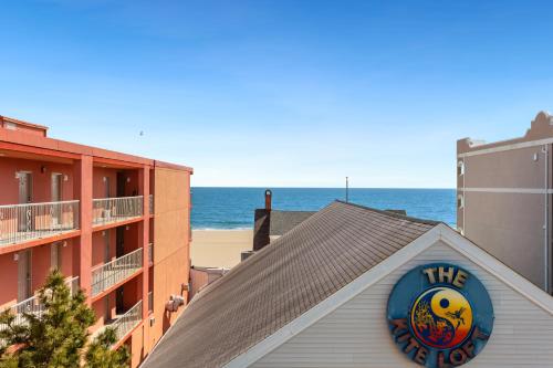 a sign on the roof of a building near the beach at Americana Motor Inn on Boardwalk in Ocean City