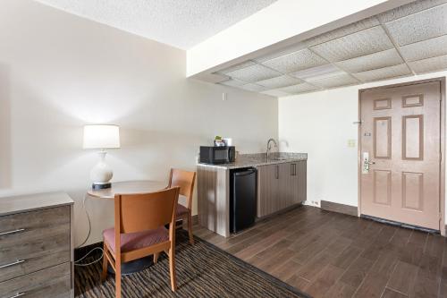 a living room with a table and a kitchen at Americana Motor Inn on Boardwalk in Ocean City