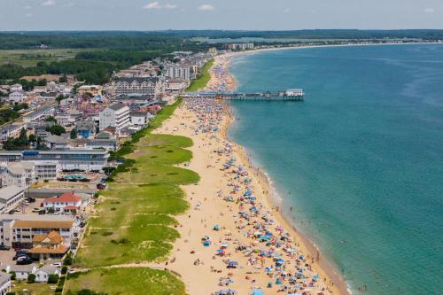 an aerial view of a beach with people and umbrellas at The Gull Oceanside Inn & Motel in Old Orchard Beach