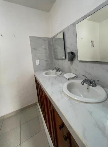 a bathroom with two sinks and a mirror at Casa Luna Family & Friends in Cancún