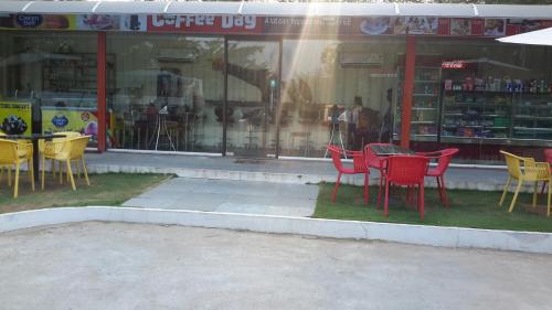 a group of chairs and tables in front of a store at Mrugavani Resort & Spa in Hyderabad