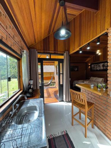 a bathroom with a tub and a sink in a room at Chalés Das Estrelas in Visconde De Maua