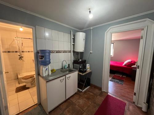 Un baño con lavabo, inodoro y ducha. en Departamento Cerca Movistar Arena, en Santiago