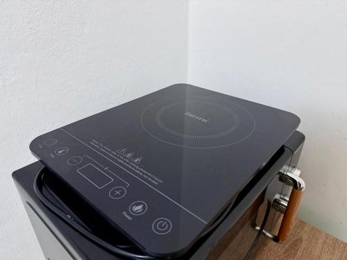 a black microwave sitting on top of a stove at Netflix - Vicino al Centro - Via Rometta Suite in Sassuolo