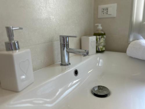 a white bathroom sink with a faucet on it at El Fossadeu-Biassa-Cinque Terre in Biassa