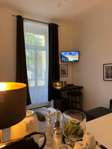 a living room with a table and a window at urban-studios-cologne I studio in Cologne