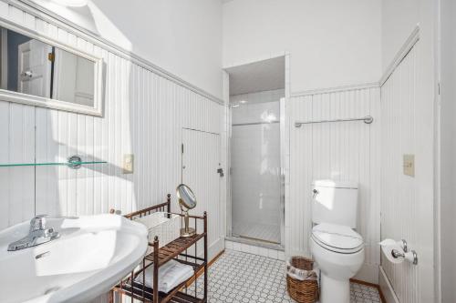 a bathroom with a toilet and a sink and a shower at Lily's Pad in Oak Island