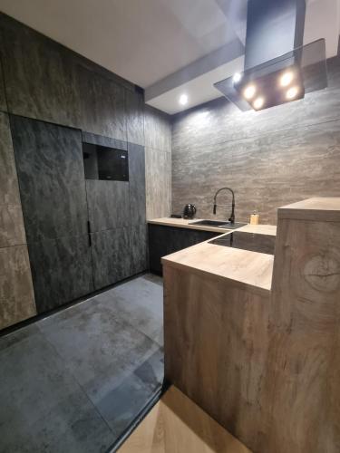 a kitchen with a sink and a counter top at Parkowa Premium Apartment in Gdynia
