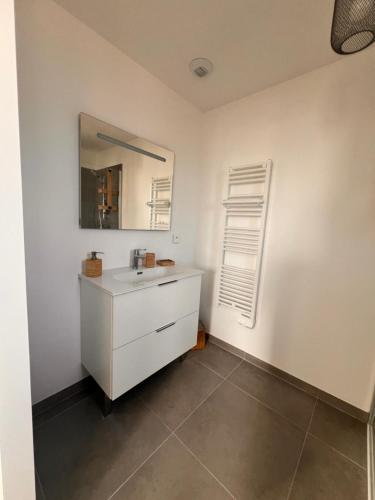 une salle de bain avec un lavabo blanc et un miroir dans l'établissement Villa neuve, piscine chauffée, à Zonza