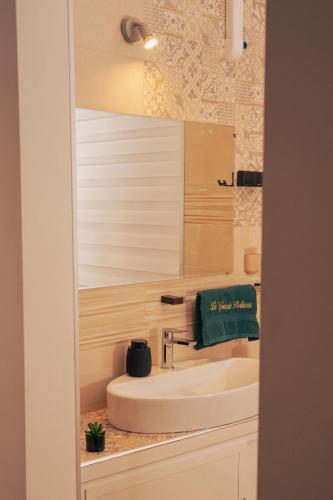 a bathroom with a sink and a mirror at La Grande Bellezza in Taranto