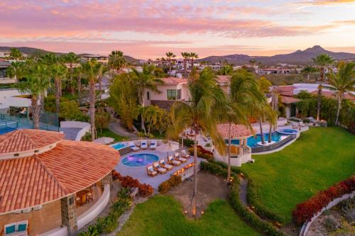 an aerial view of a resort with a pool and palm trees at Spacious 5 Bd Villa Fully Staffed w Chauffeur in Puerto Los Cabos! in San José del Cabo