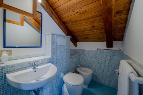 a bathroom with a white sink and a toilet at Maison Antica - One Step Away From the Sea in Maiori