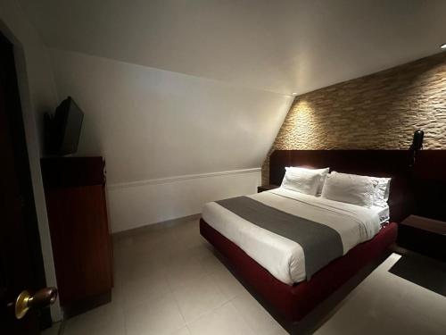 a hotel room with a bed and a television at Lavid Hotel Palacio Real in Bogotá