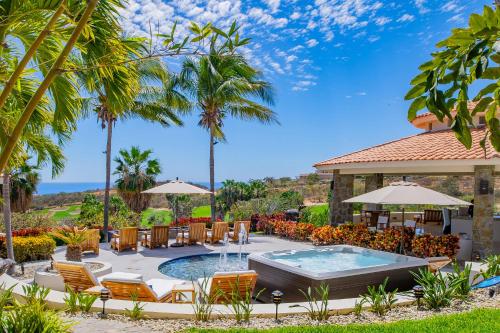 a resort with a pool and chairs and a pavilion at Spacious 5 Bd Villa Fully Staffed w Chauffeur in Puerto Los Cabos! in San José del Cabo