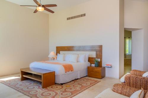 a bedroom with a large bed and a couch at Spacious 5 Bd Villa Fully Staffed w Chauffeur in Puerto Los Cabos! in San José del Cabo