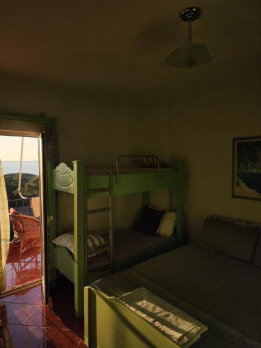 a room with a bunk bed and a couch at Vistamar Apartment in Golem