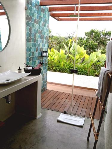 a bathroom with a shower and a sink and a window at Rancho Eden in Armenia