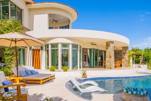 a villa with a swimming pool and a house at Spacious 5 Bd Villa Fully Staffed w Chauffeur in Puerto Los Cabos! in San José del Cabo