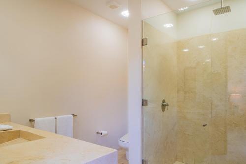 a bathroom with a shower and a toilet at Spacious 5 Bd Villa Fully Staffed w Chauffeur in Puerto Los Cabos! in San José del Cabo
