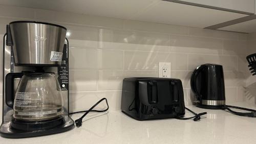 a kitchen counter with a blender and a toaster at Private Very Spacious 2 bed 1-Bedroom basement Suite SW Calgary in Calgary