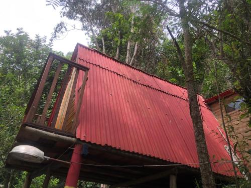 a red roofed house with a red roof at Pousada e Hostel Cantinho dos Chalés in São Luiz do Paraitinga