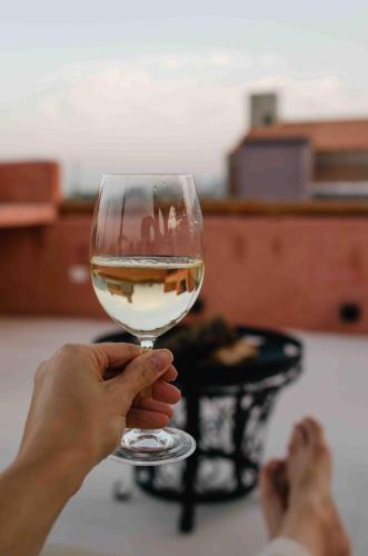 a person holding up a glass of wine at WAYTAY in Cafayate