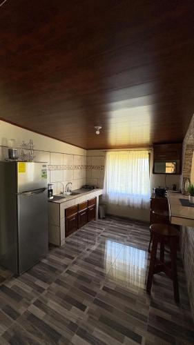 a kitchen with a stainless steel refrigerator and a sink at Skyline Great View in Lourdes
