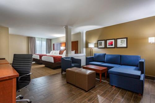 a hotel room with a couch and a bed at Comfort Suites Bowling Green Southeast in Bowling Green