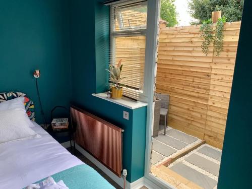 a room with a bed and a window with a fence at Modern with parking near Windsor Castle & Legoland in Windsor