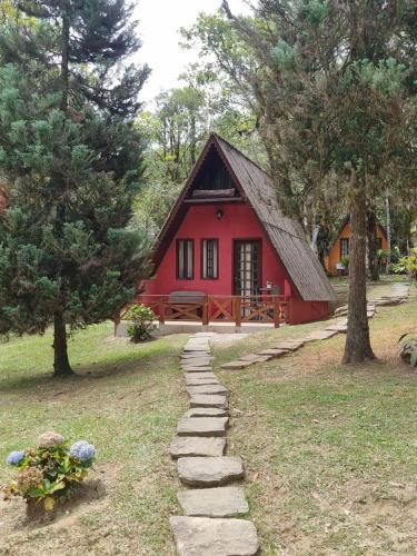 a red house with a path leading to it at A Luz Azul - Pousada e Gastronomia in Bananal